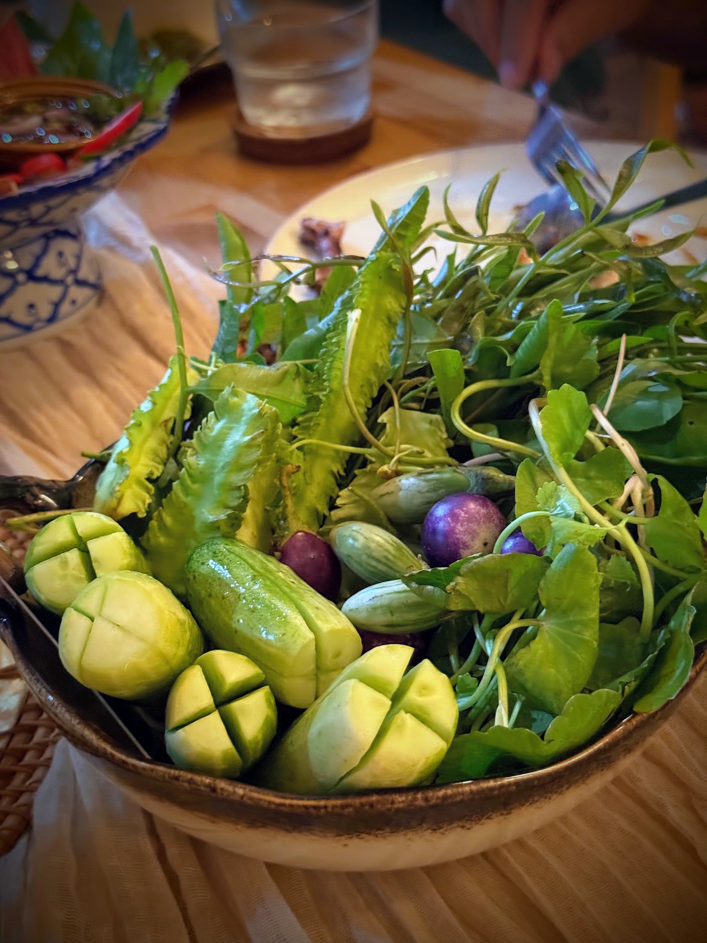 Bowl of fresh Thai herbs, vegetables and winged beans