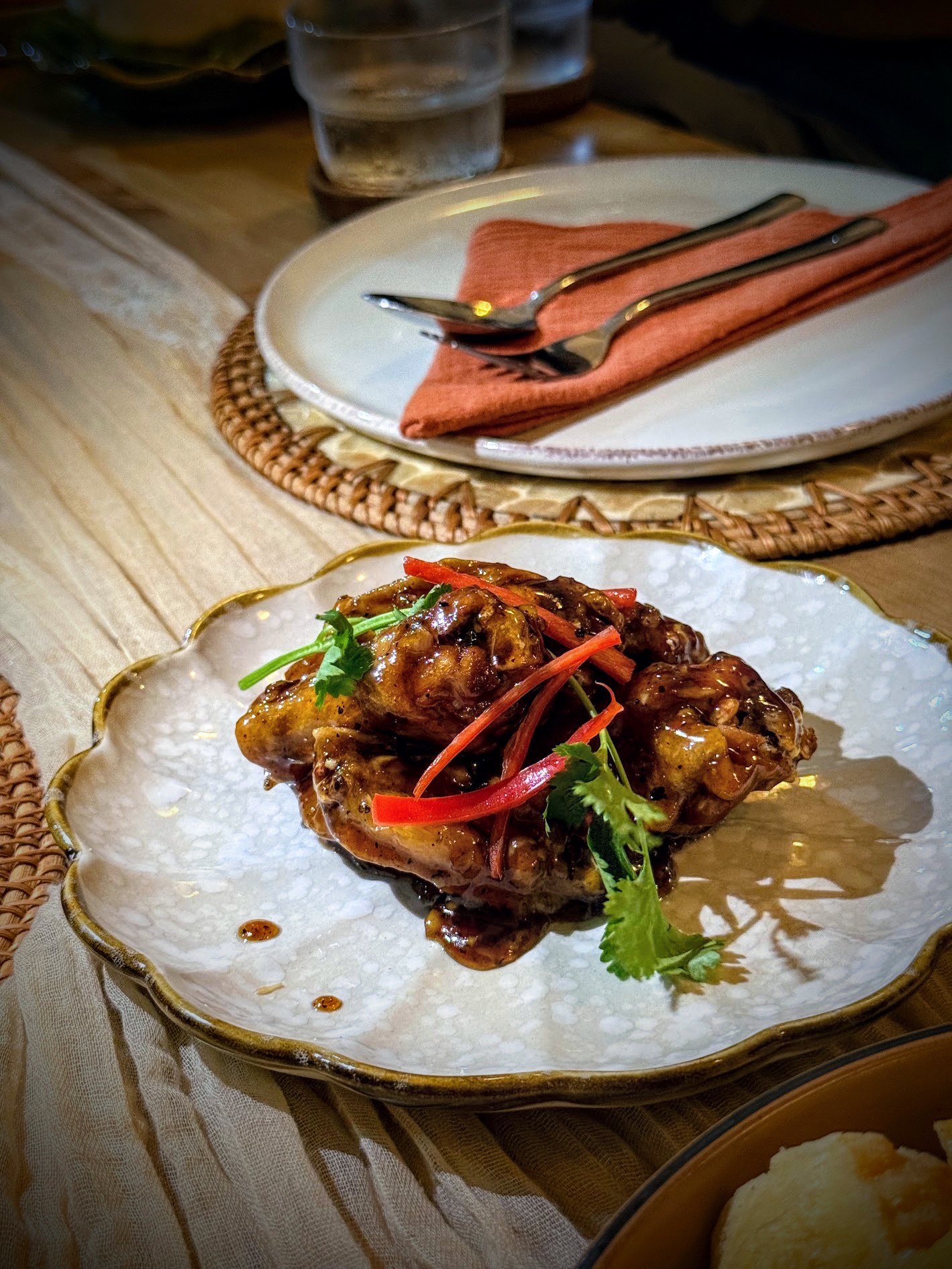 Glazed chicken wings with coriander and red chilli