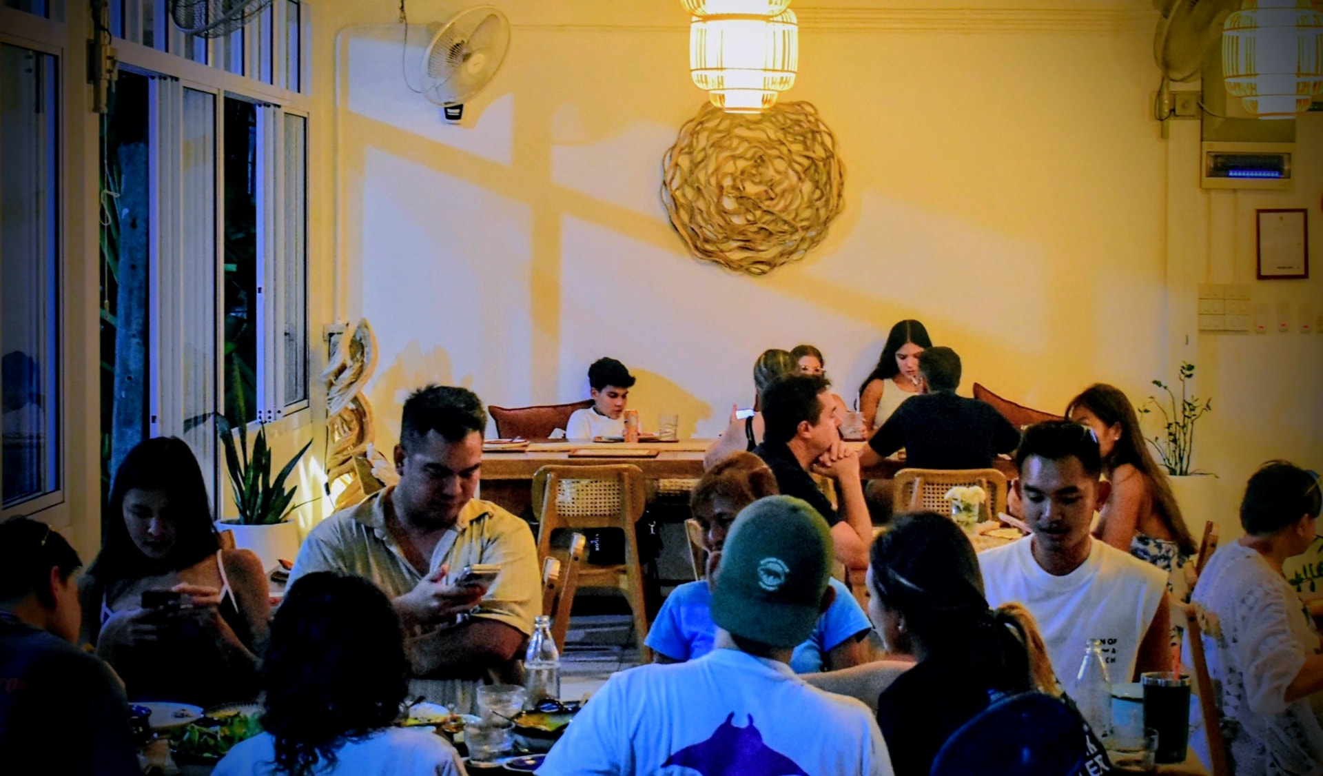 Guests dining in the warm-lit inner room