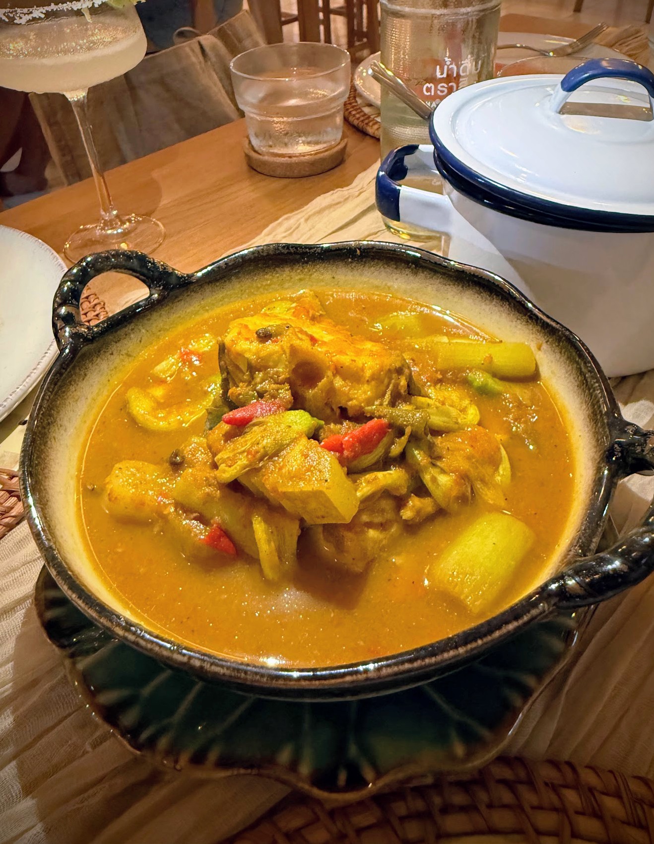 Slow-cooked massaman curry in a stoneware pot