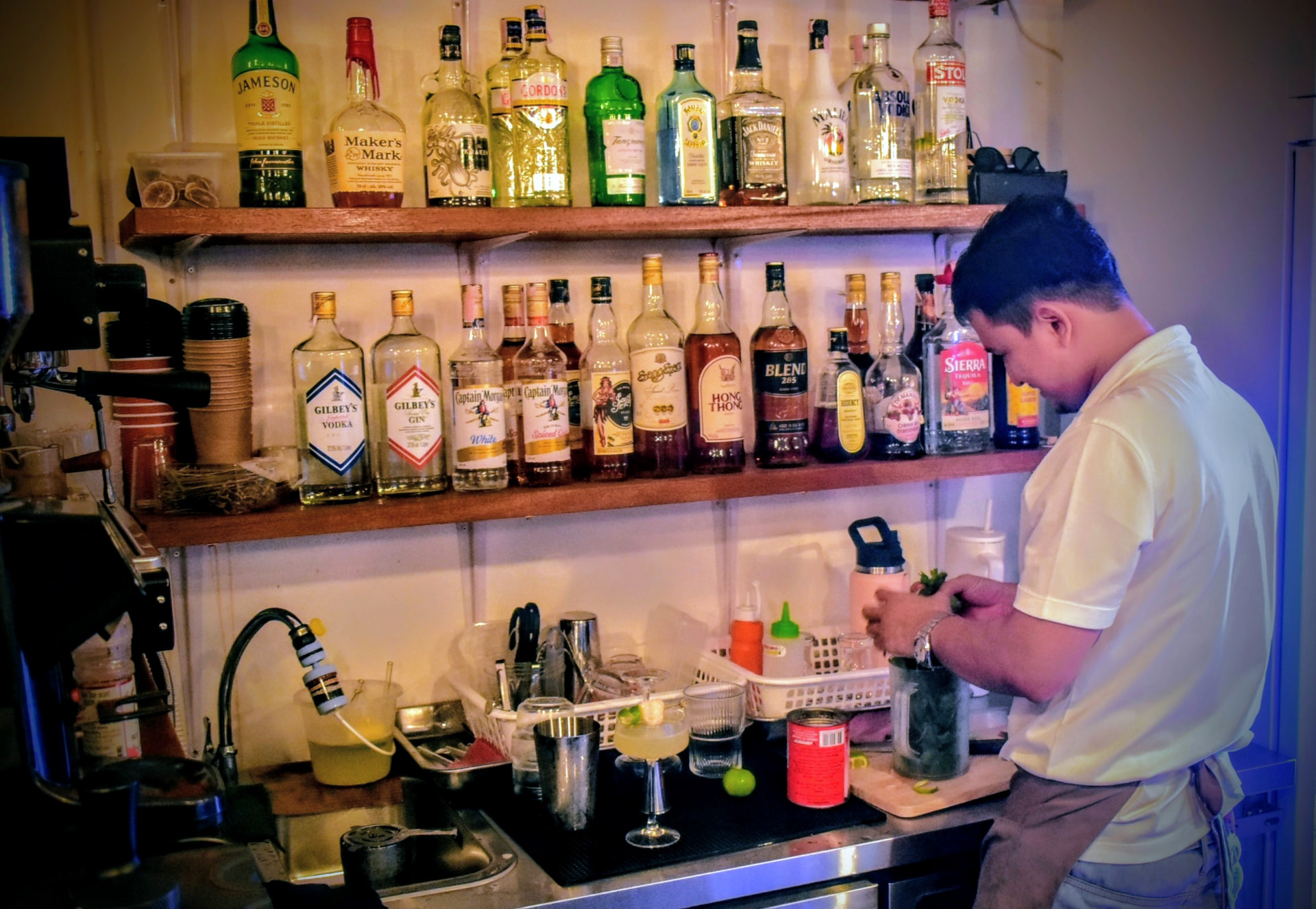 Bartender mixing a cocktail behind the bar
