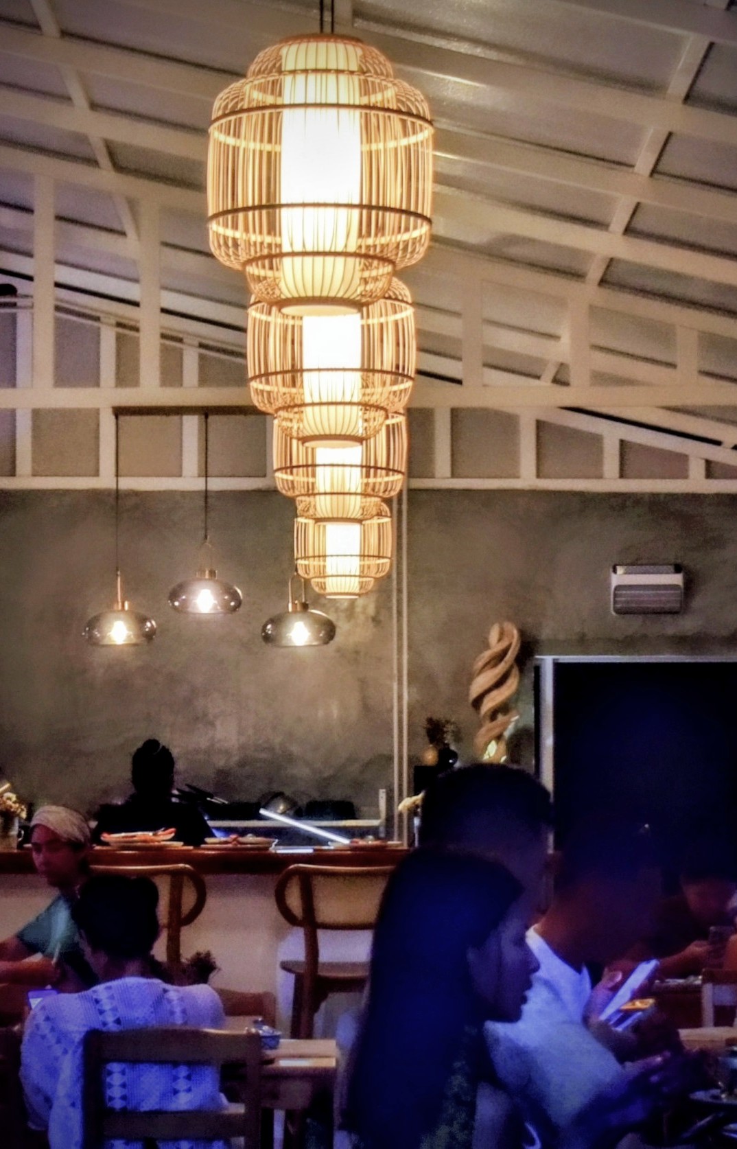 Stacked rattan lanterns hanging from the ceiling