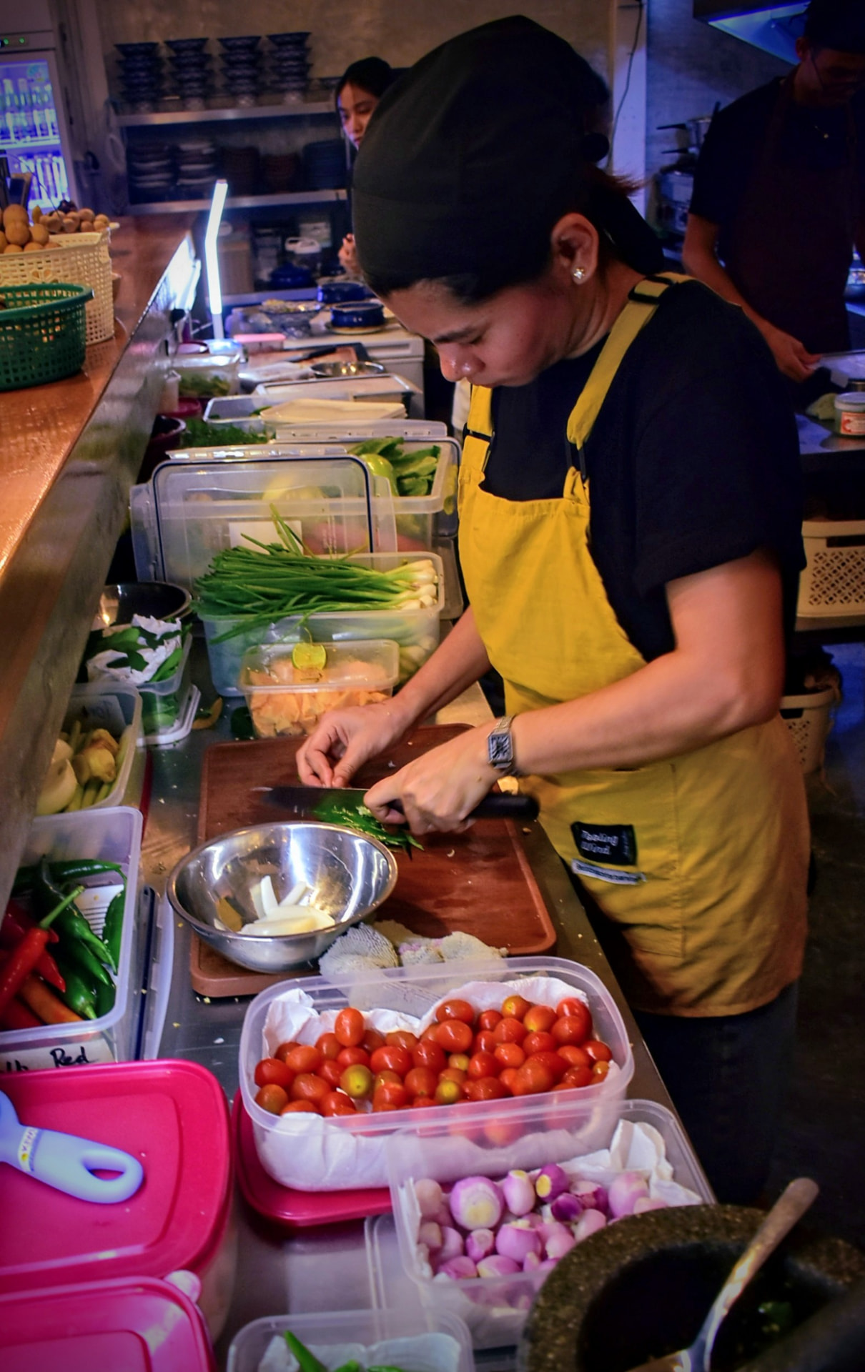 Sous chef preparing fresh herbs and vegetables