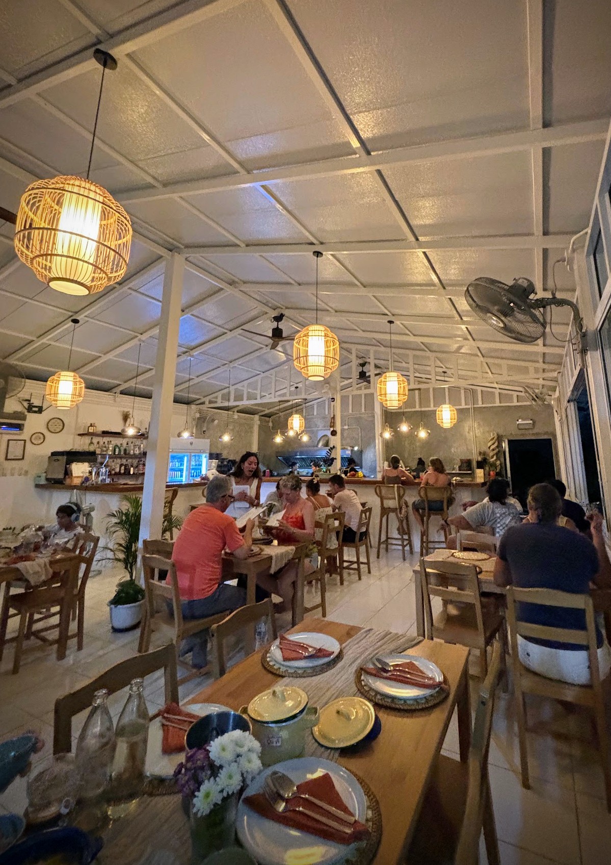 Rattan lanterns above set tables in the dining room
