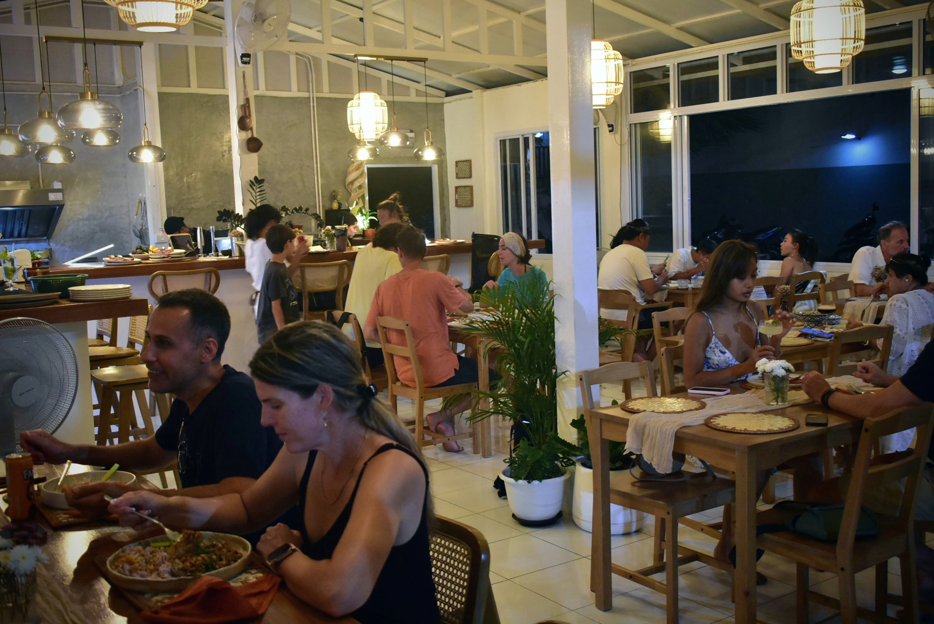 Busy dining room with guests enjoying Thai dishes